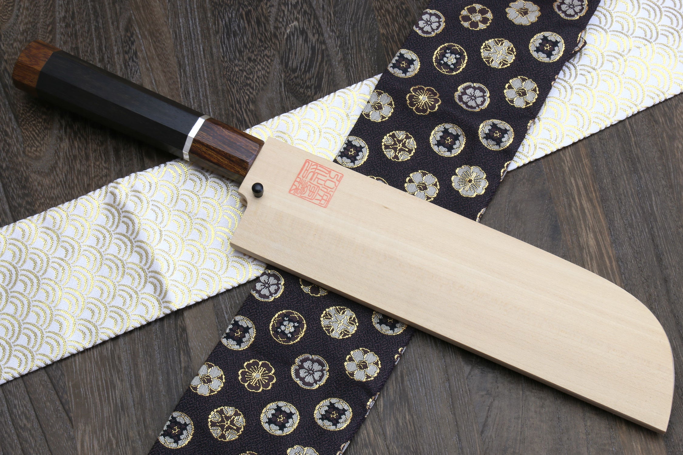 Japanese chef knife with ebony handle, silver ring, and wooden sheath