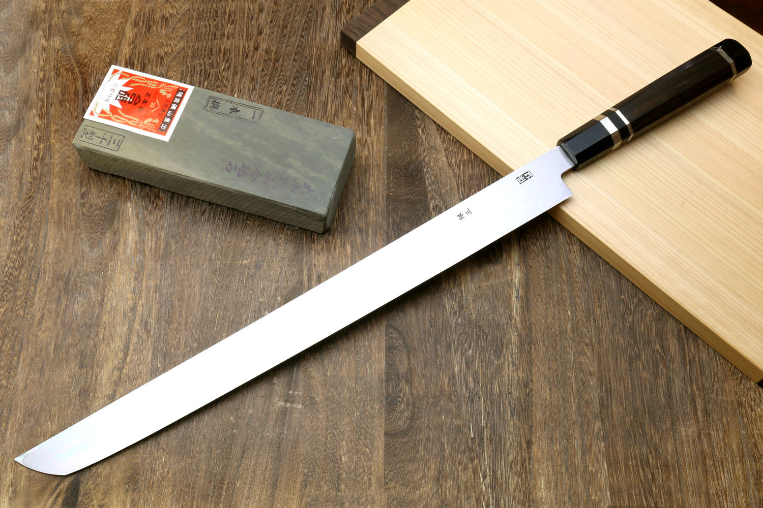Tuna knife with long white steel blade, ebony handle with silver ring accents