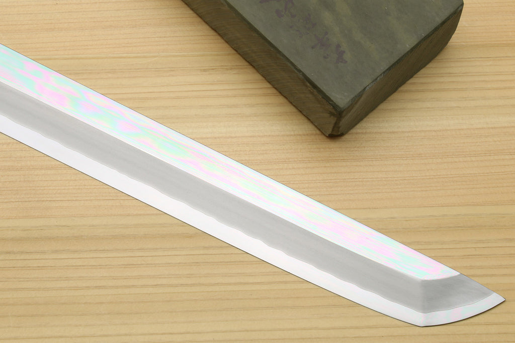 Mirror-polished tuna knife blade edge detail with subtle iridescent sheen
