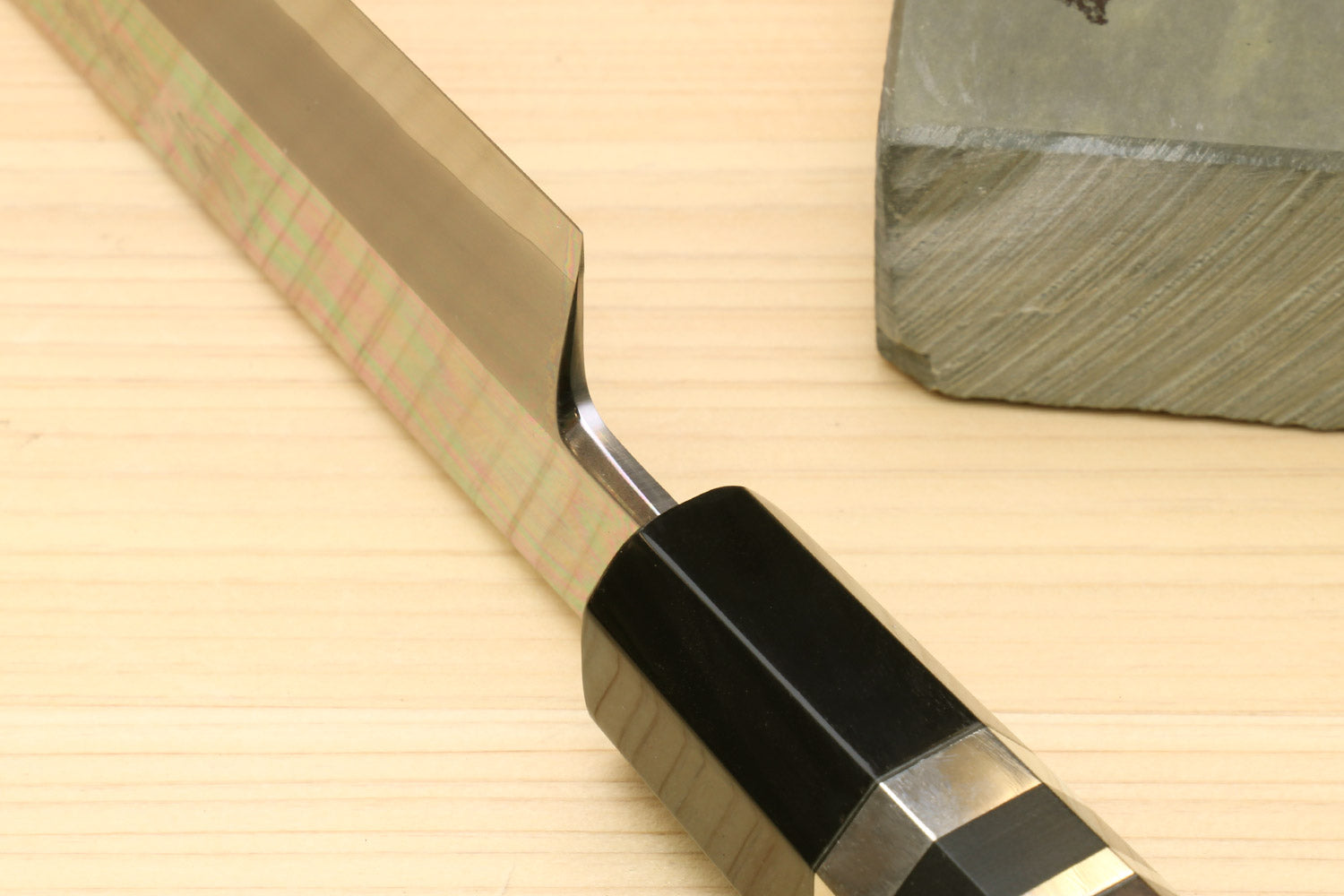 Ebony handle section of tuna knife with silver ring and dark metal bolster