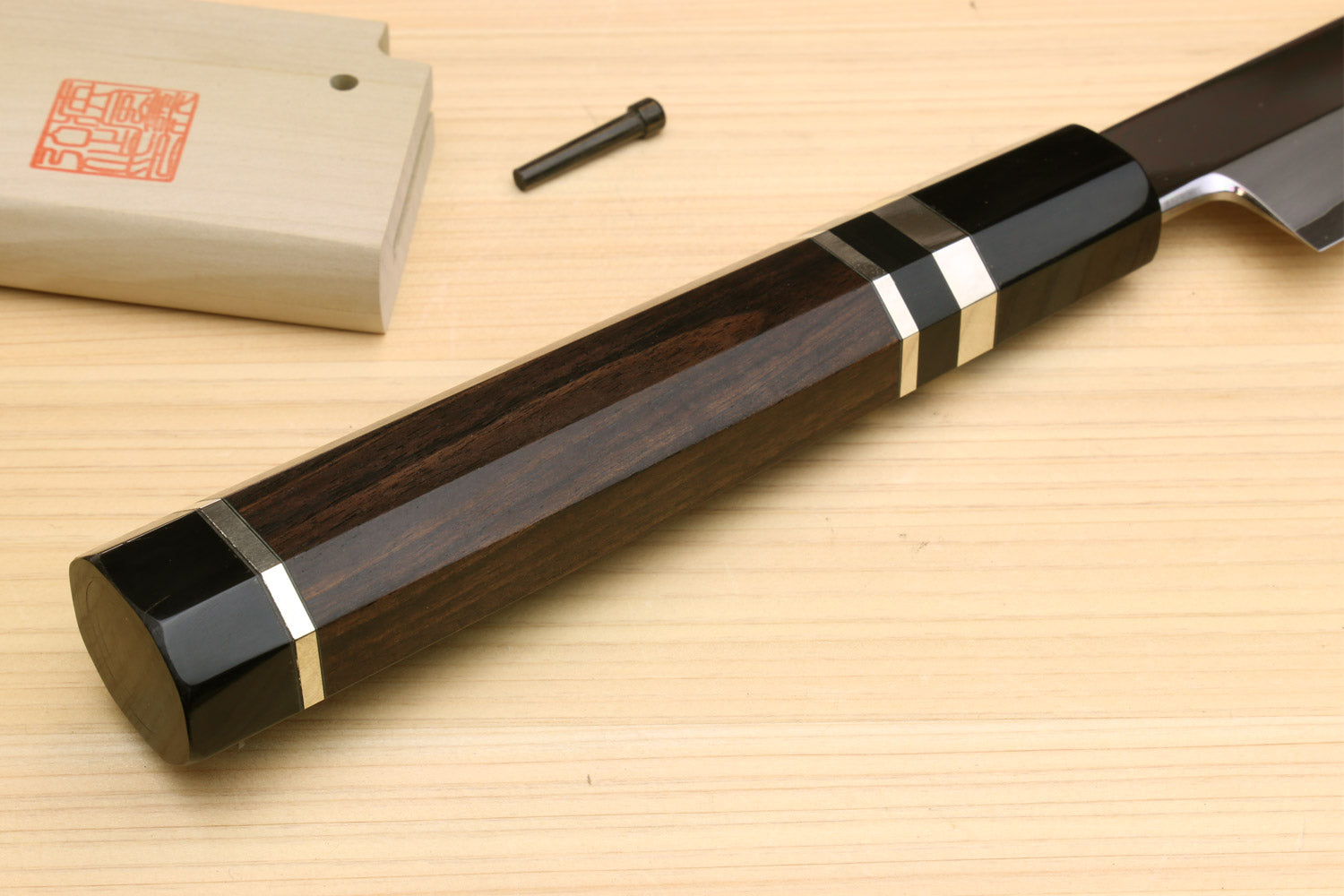 Tuna knife with dark wood handle, triple silver rings, and polished steel blade