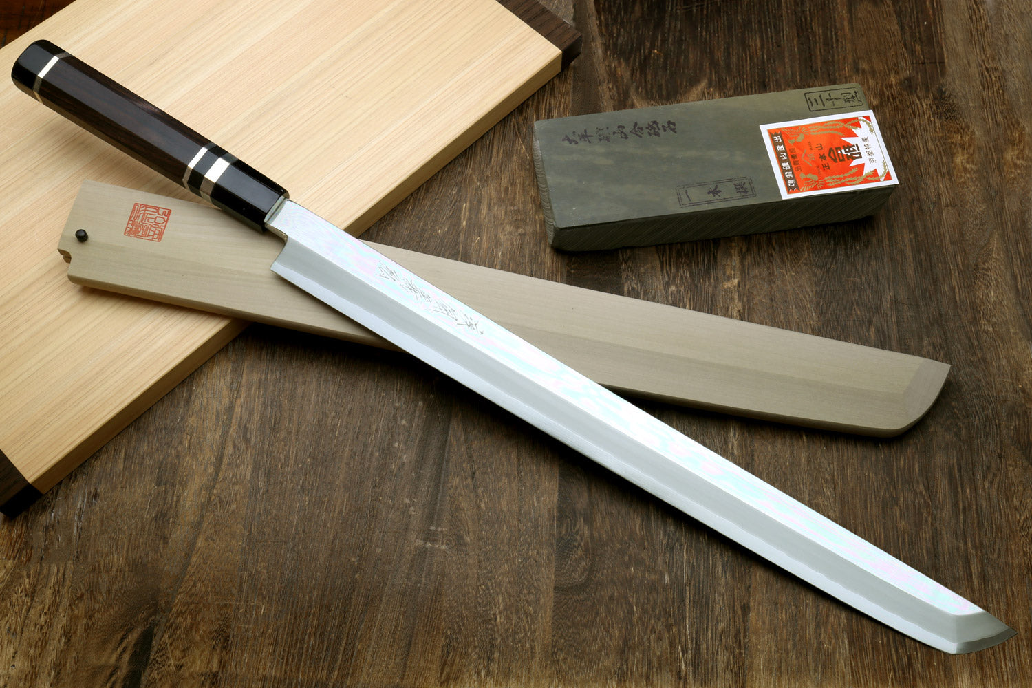 Tuna knife with mirror-polished blade, ebony handle, and silver ring accents