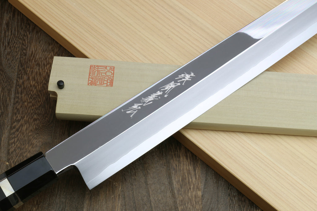 Yanagi-kiritsuke tuna knife with mirror blade and ebony handle, Japanese text on blade