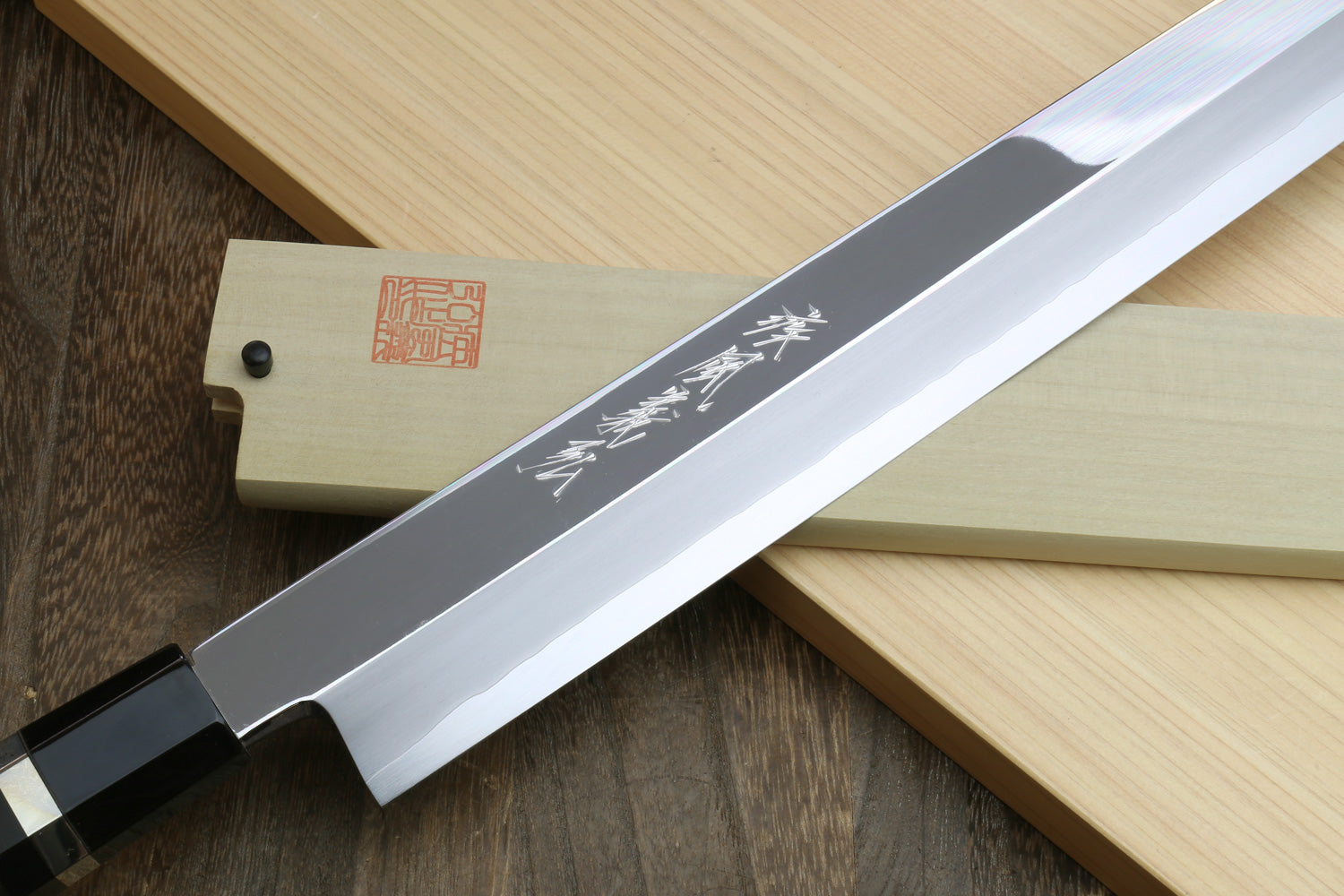 Yanagi-kiritsuke tuna knife with mirror blade and ebony handle, Japanese text on blade