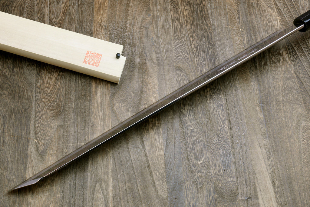 Yanagi-kiritsuke tuna knife with long mirror-polished steel blade and light wooden saya