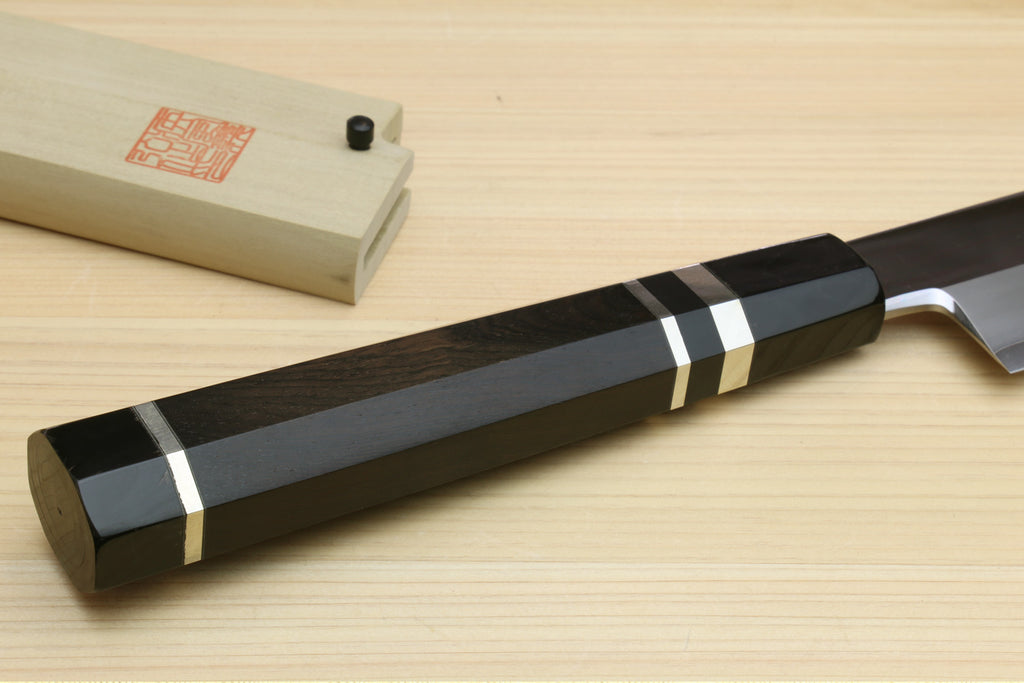 Yanagi-style tuna knife on wooden blocks; black handle with silver rings and long blade