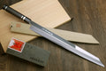 Yanagi-kiritsuke tuna knife with mirror blade, ebony handle, and pale wooden saya
