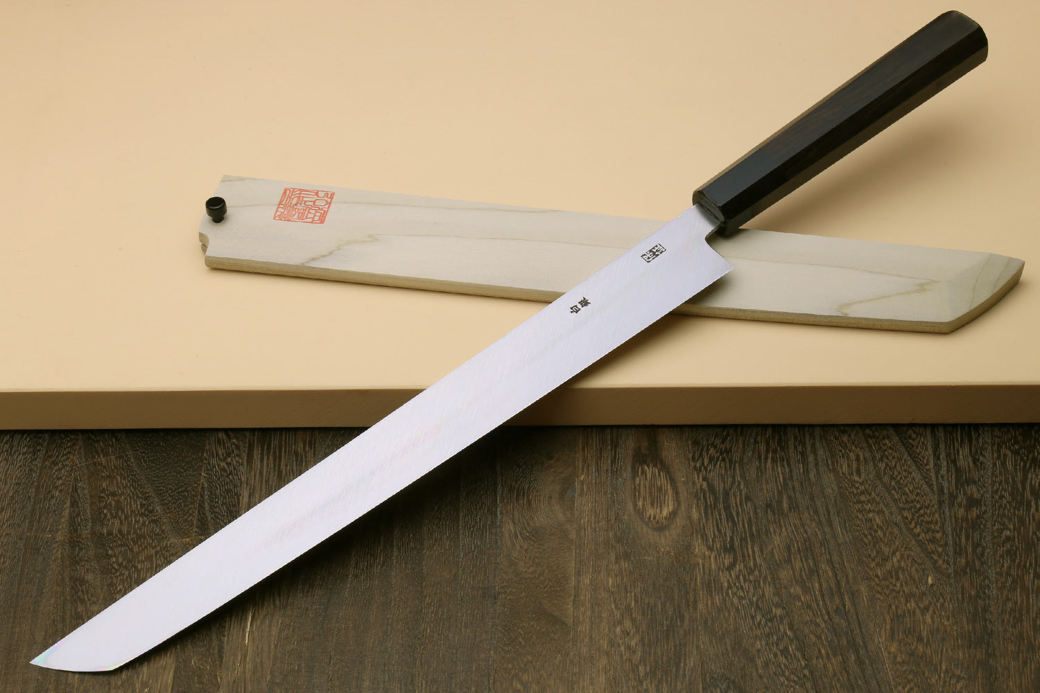 Japanese sashimi slicing knife with mirror-polished steel blade and ebony handle