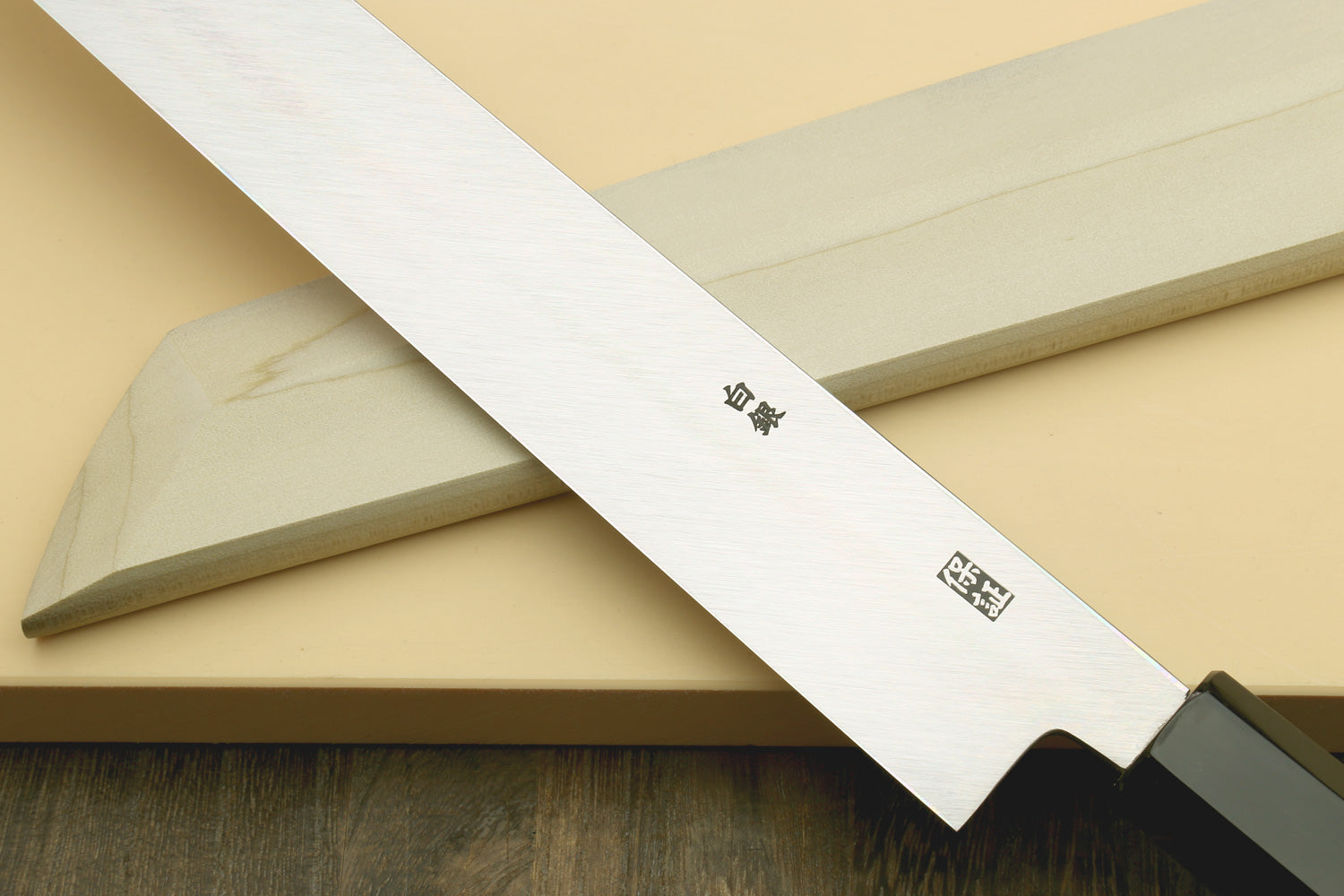 Japanese slicing knife blade with etched markings and black handle