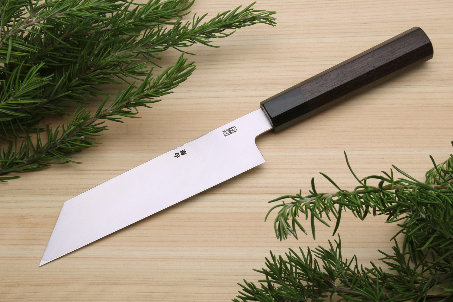 Single-edged vegetable knife with dark handle and white blade, pointed tip