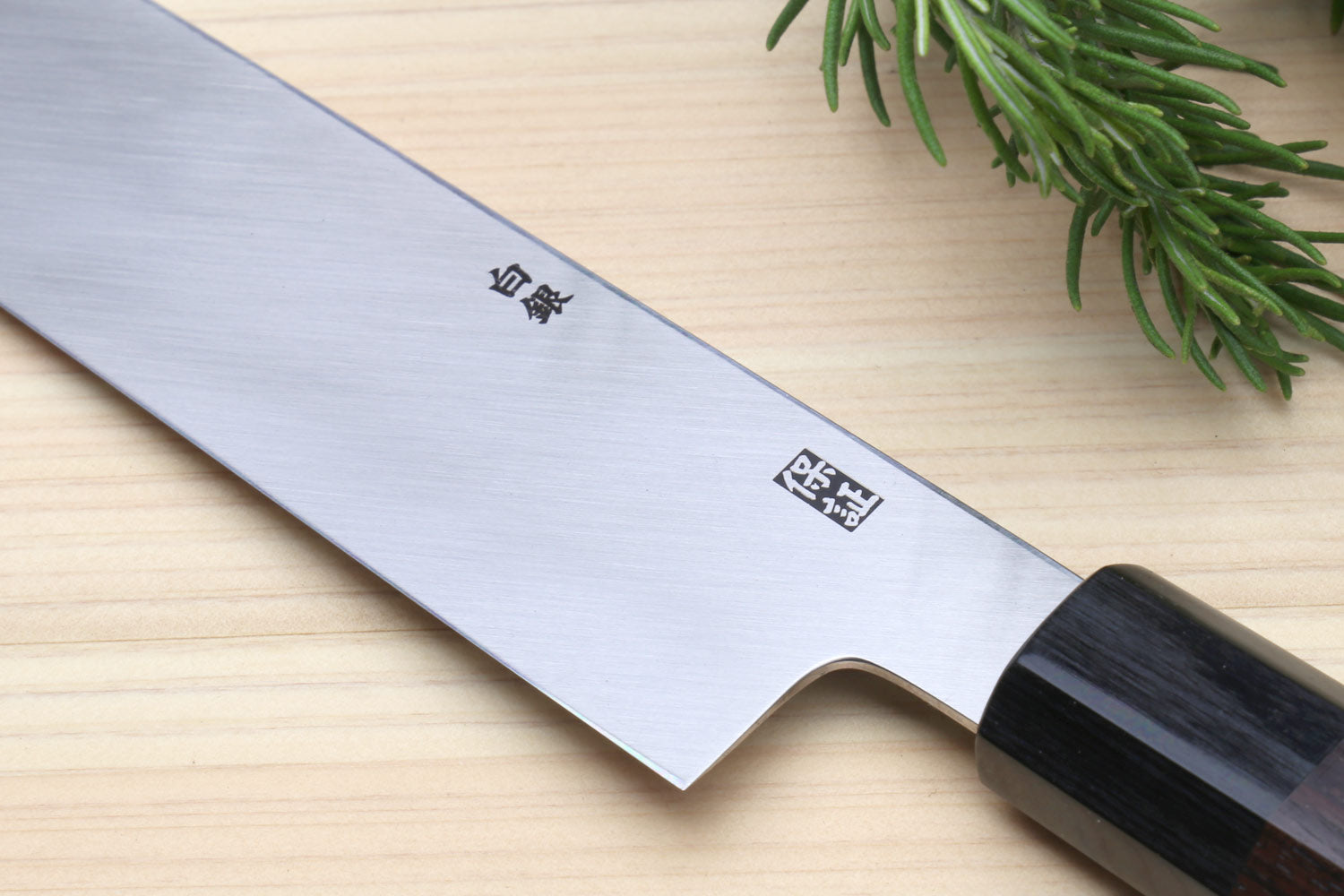Single-edged vegetable knife with engraved blade and dark wooden handle