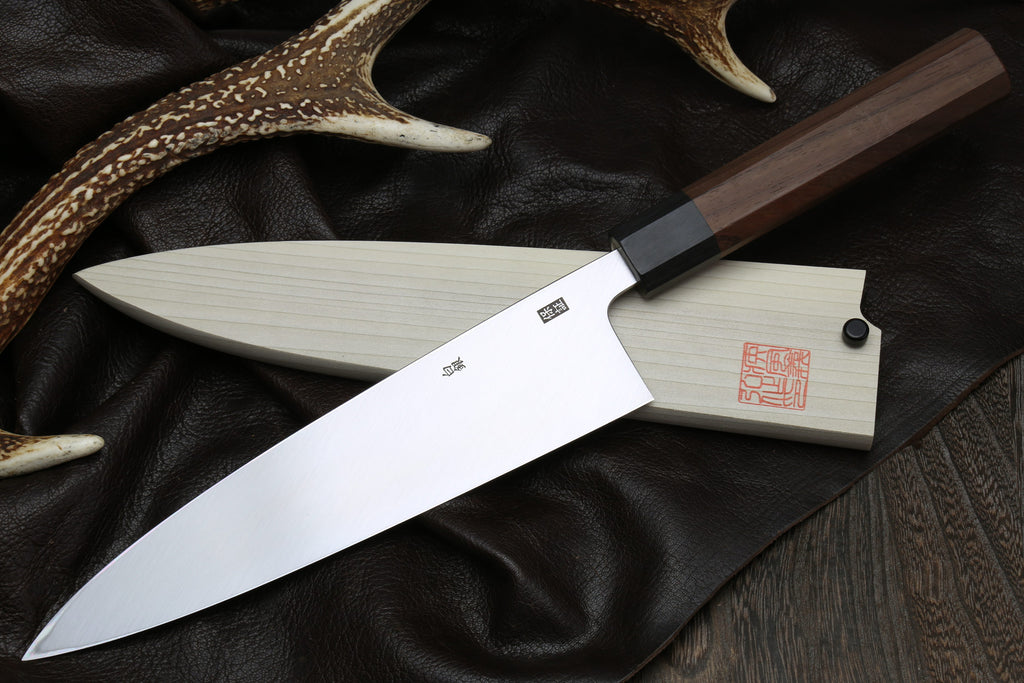 Japanese filet knife with pale blade, dark handle, and black spacer