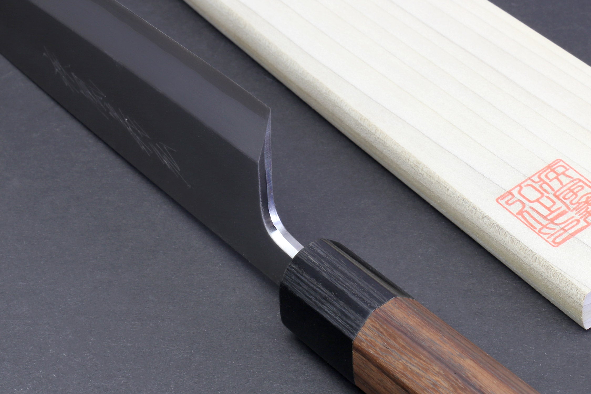 Japanese filet knife pair with dark blade and light handle, single edge