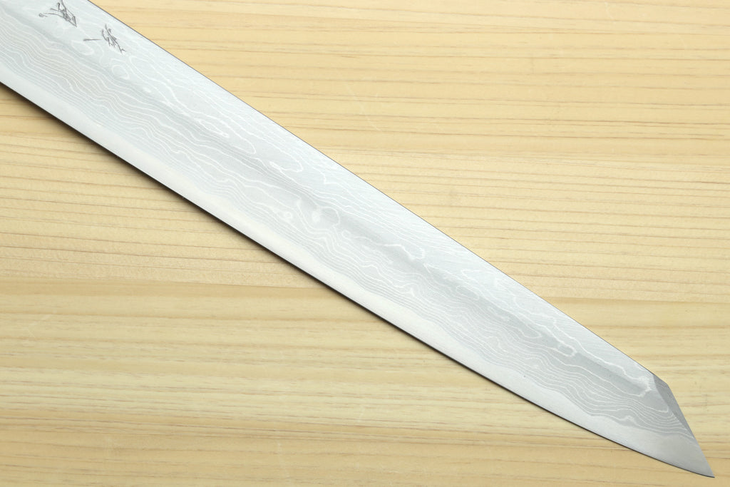 Japanese sushi knife with long pointed wavy Damascus blade.