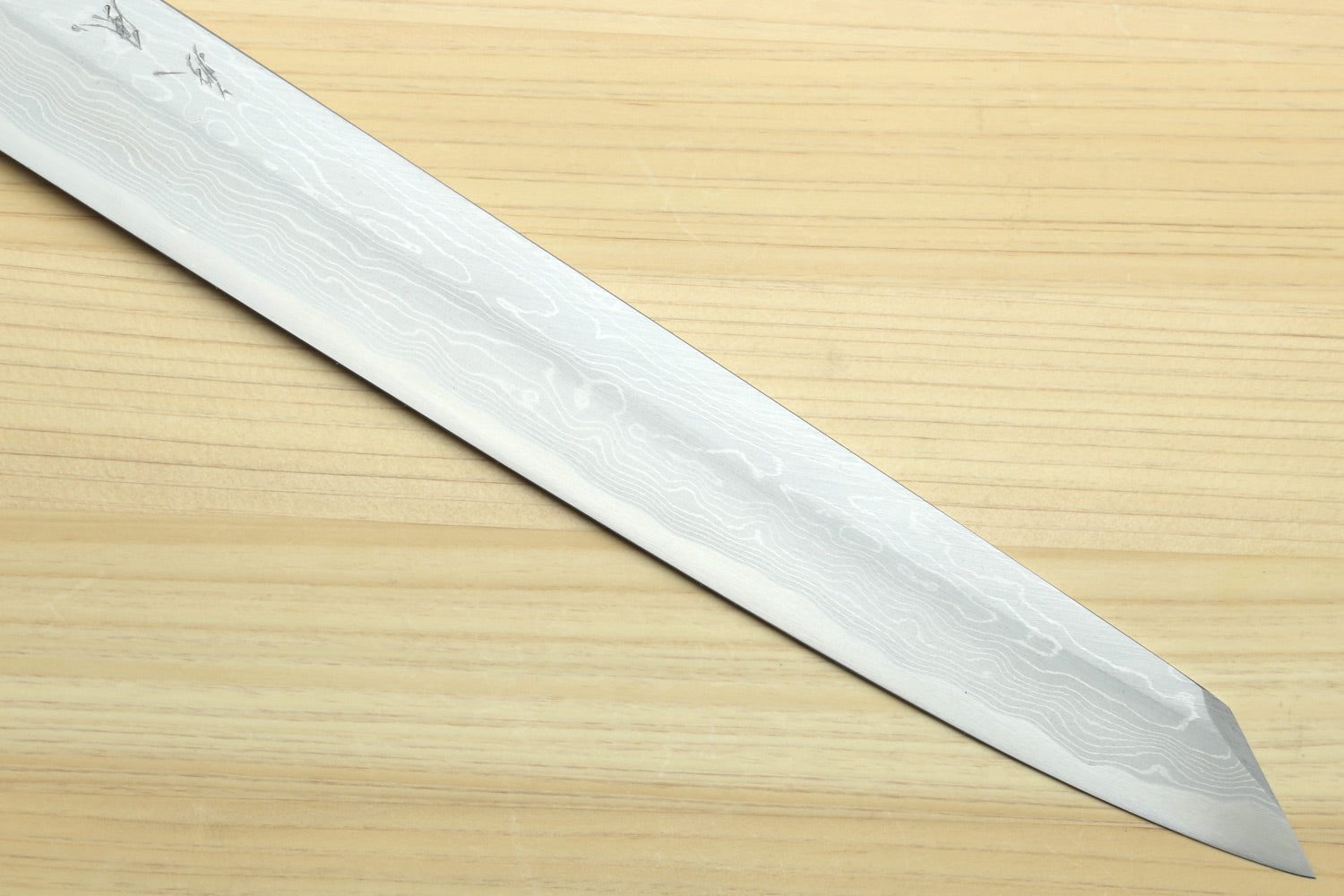 Japanese sushi knife with long pointed wavy Damascus blade.