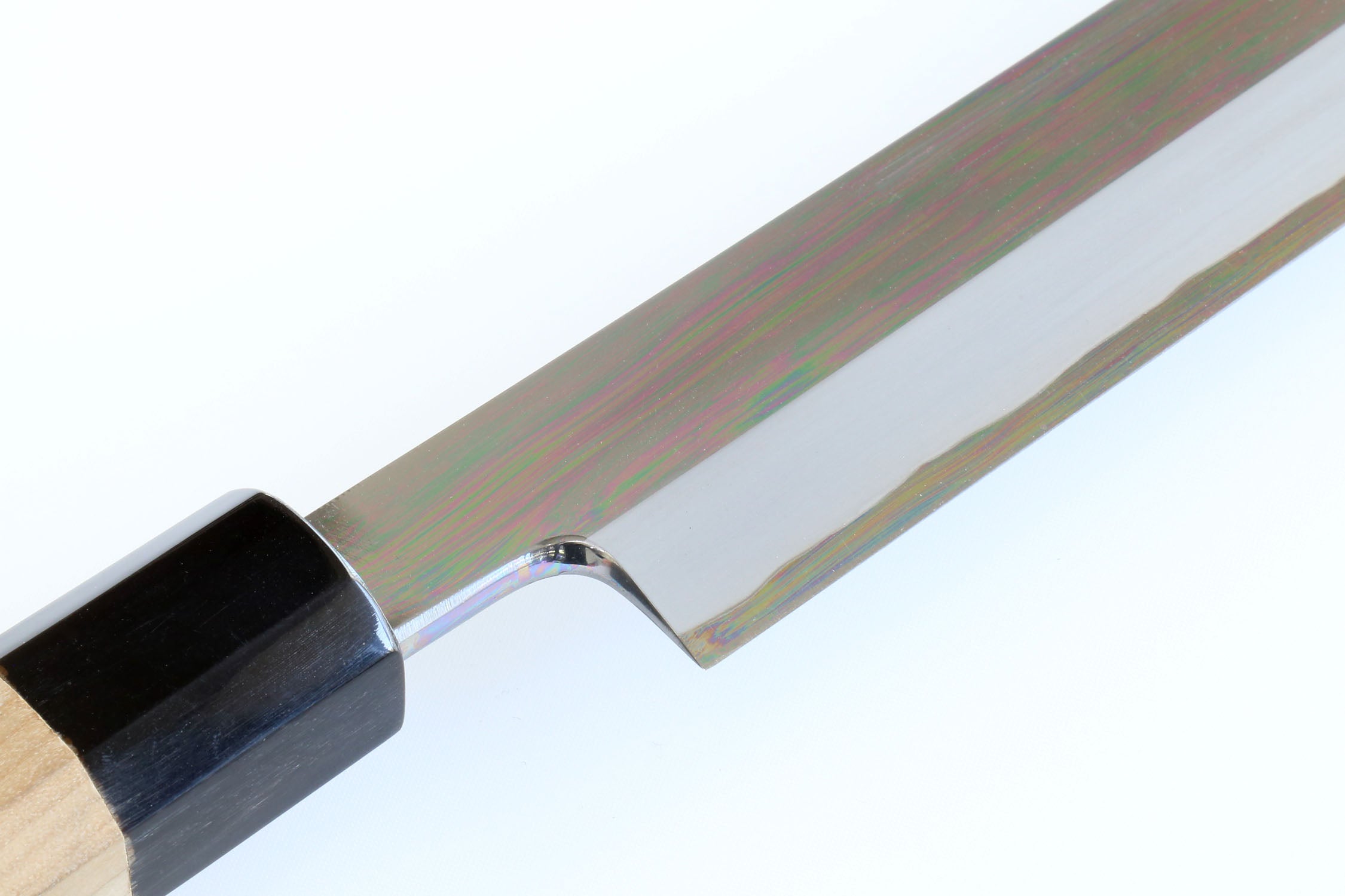 Tuna knife handle and blade junction with black bolster and polished steel