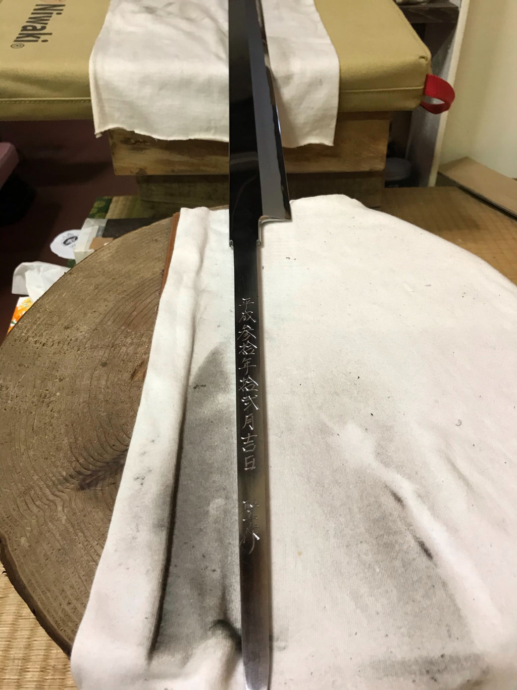 Single-edged tuna knife with dark steel blade and etched kanji characters