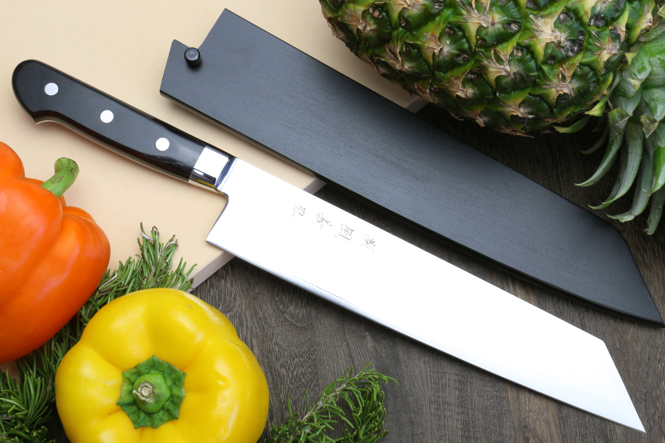Kiritsuke chef knife with black pakkawood handle and white blade, 210mm