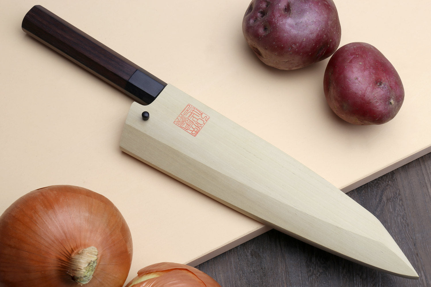 Traditional Japanese garasuki boning knife with dark rosewood handle, blue steel blade