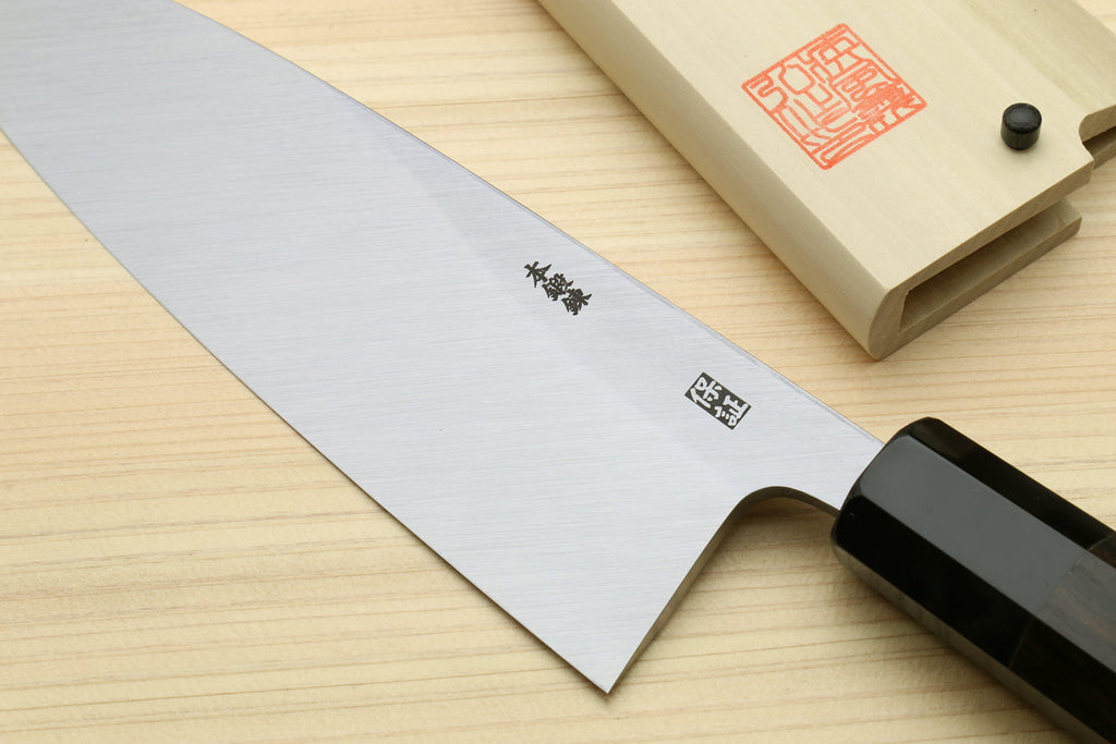 Deba fish knife with silver blade featuring etched symbols and black handle