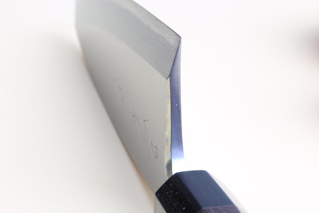 Deba fish fillet knife close-up of steel blade and dark shitan handle
