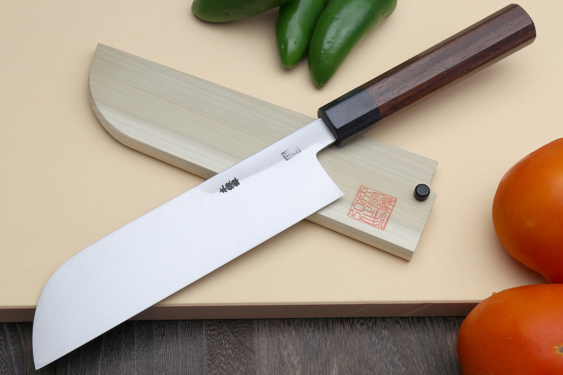 Japanese vegetable knife with long curved blade and rosewood handle, shown with sheath