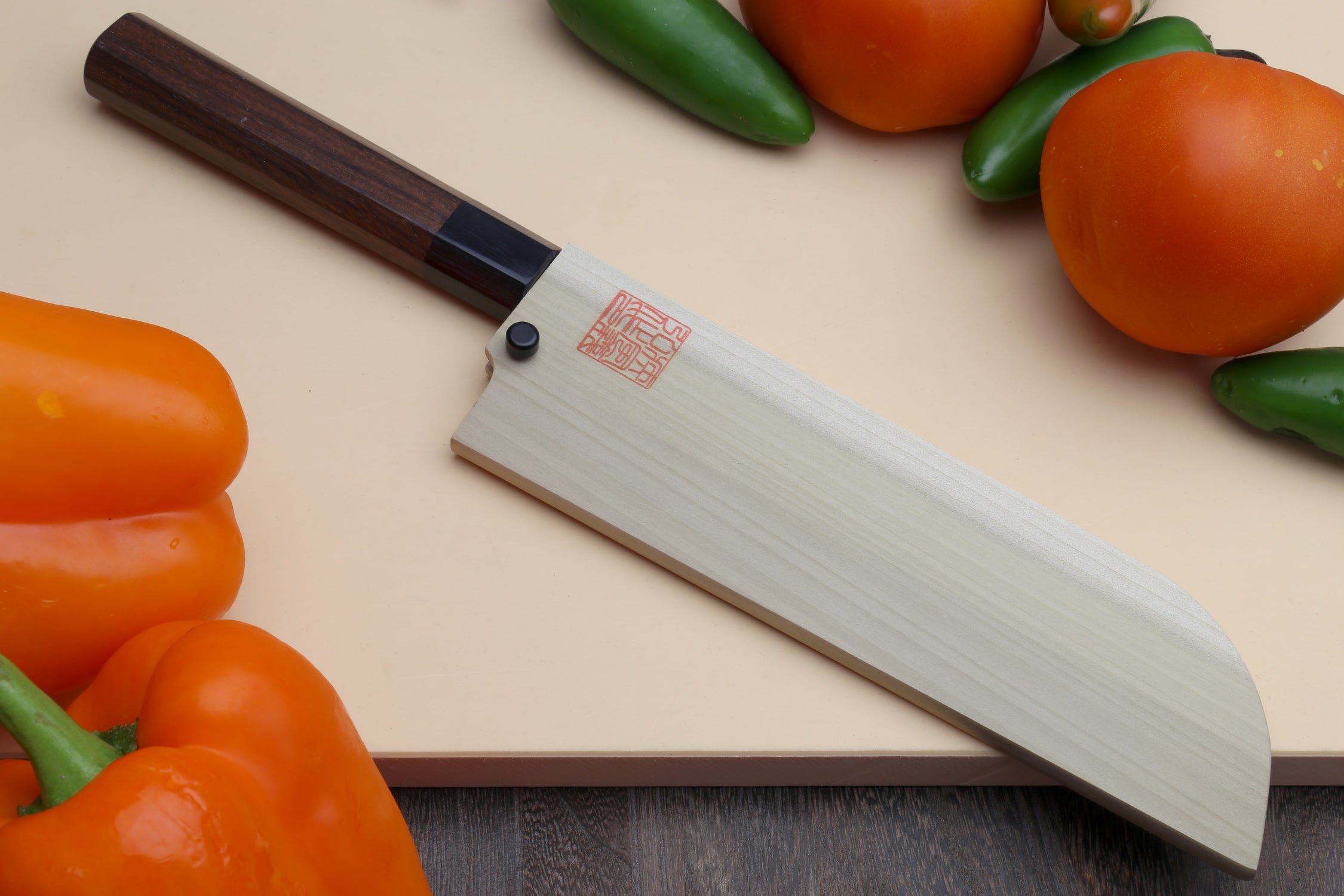 Japanese vegetable chopping knife with rosewood handle and blue steel blade, front view