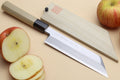 Japanese chef knife with light wooden handle and dark bolster, polished steel blade