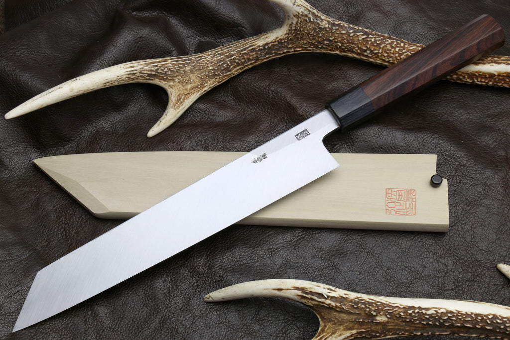 Japanese chef knife set: pale blade with dark handle, with matching horn-like guards