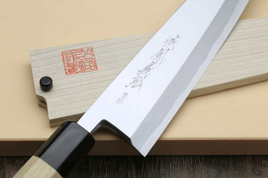 Japanese chef knife showing black collar and engraved silver blade