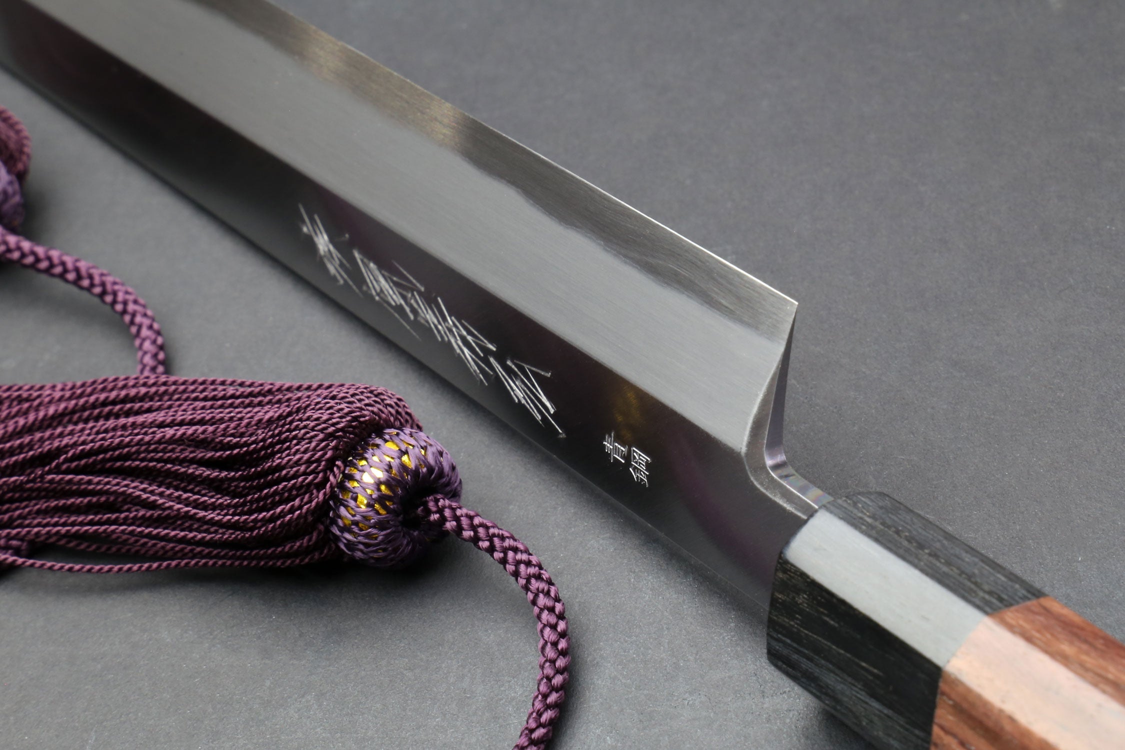 Yanagi-kiritsuke knife blade with engraved markings and cord tied sheath