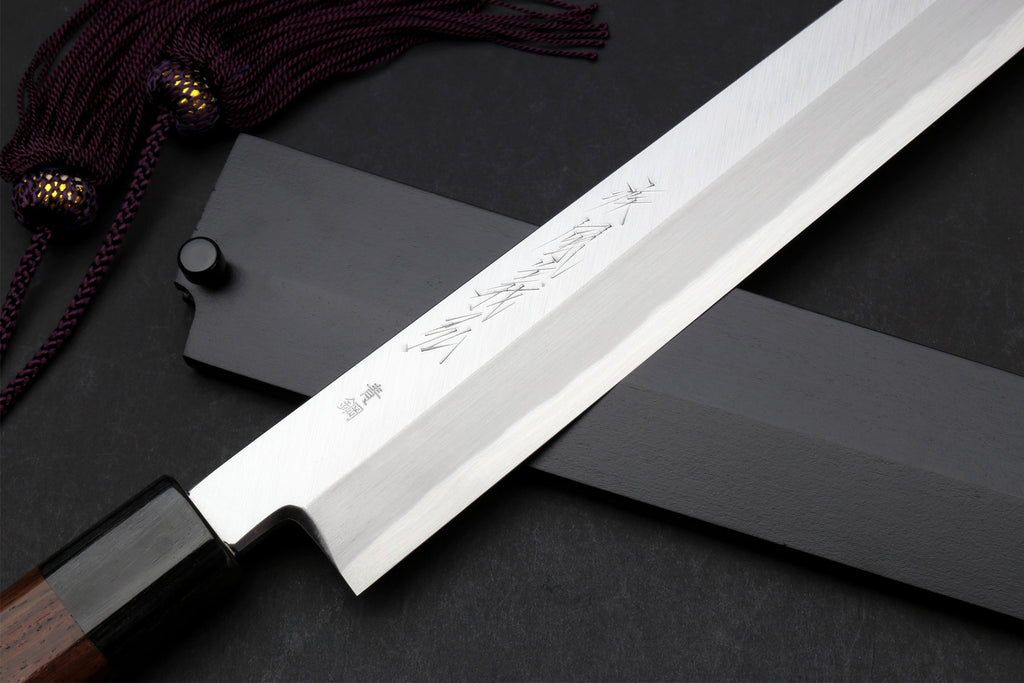 Japanese yanagi knife with engraved blade, rosewood handle, and sheath with cord