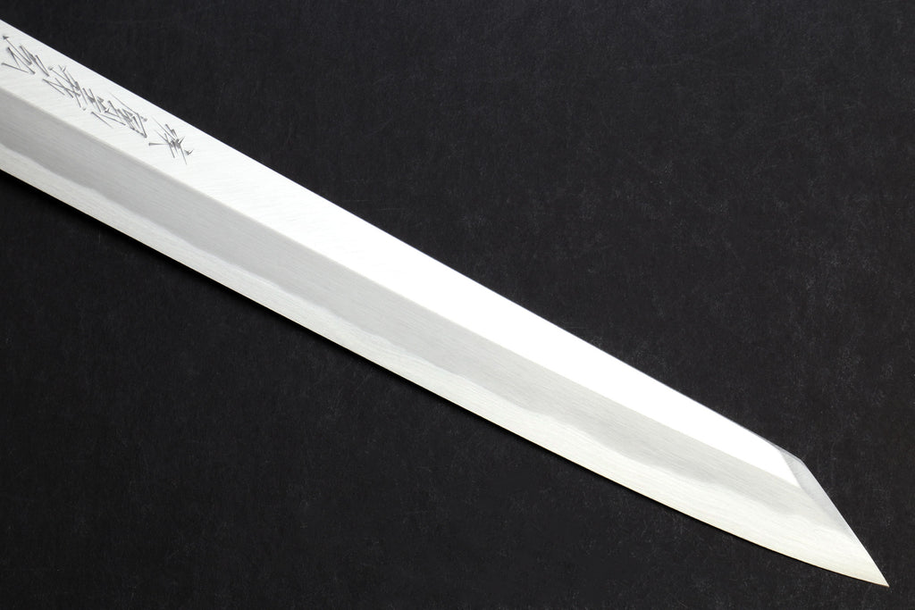 Japanese yanagi knife blade with decorative etching along the flat