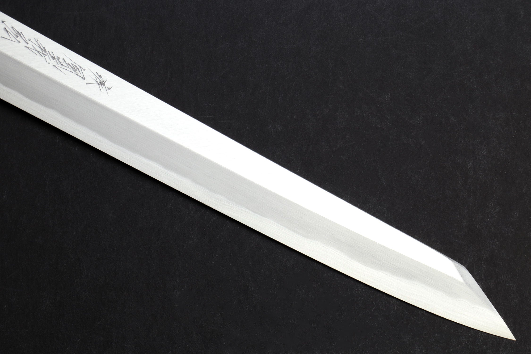 Japanese yanagi knife blade with decorative etching along the flat
