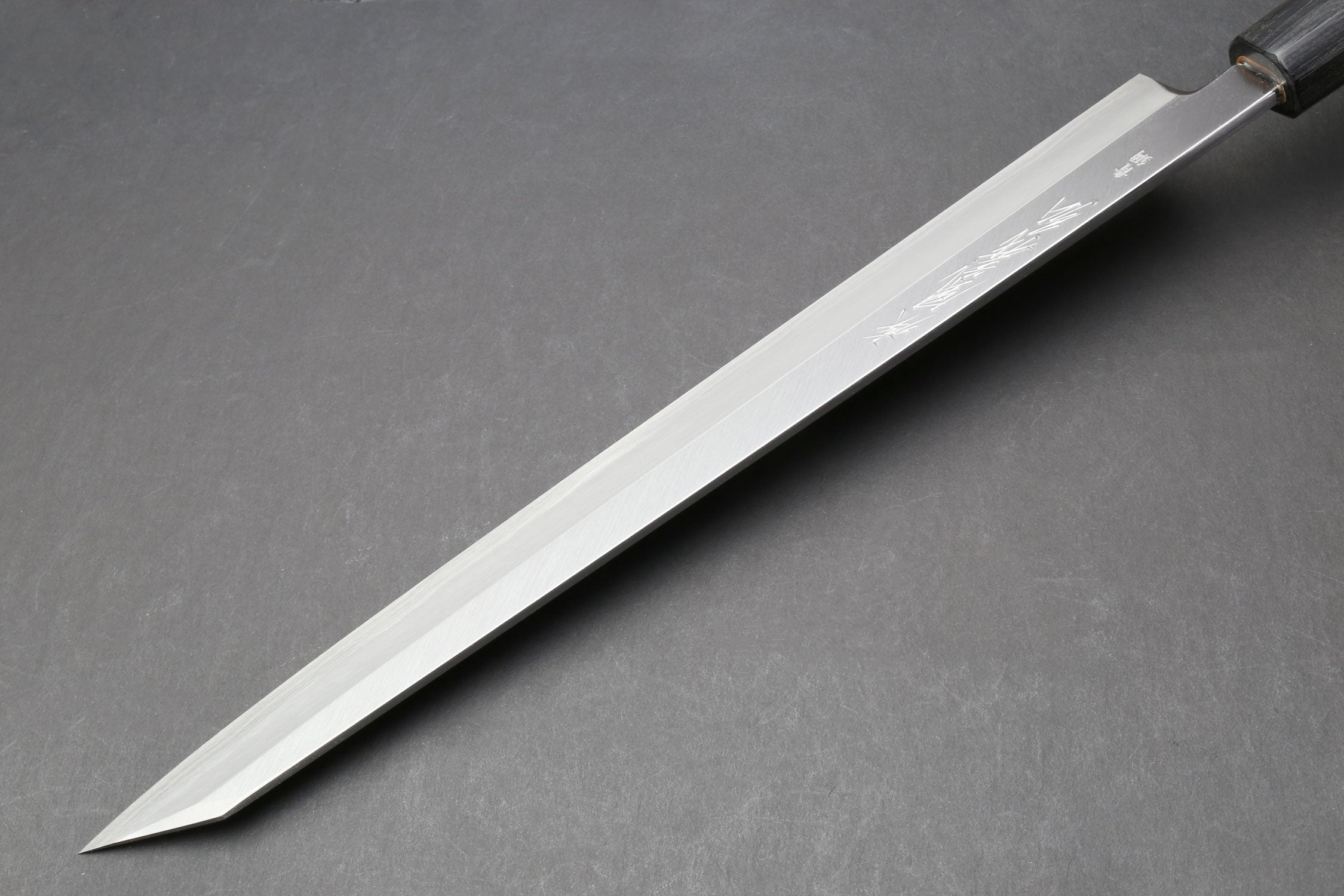 Japanese yanagi knife with long tapered blade and rosewood handle