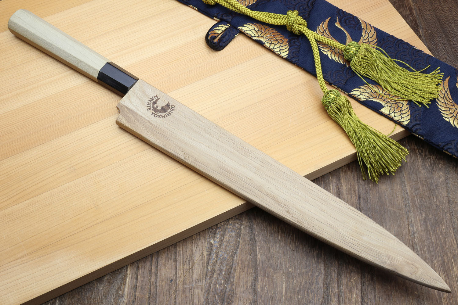 Japanese sashimi knife with long silver blade and magnolia handle, black bolster detail
