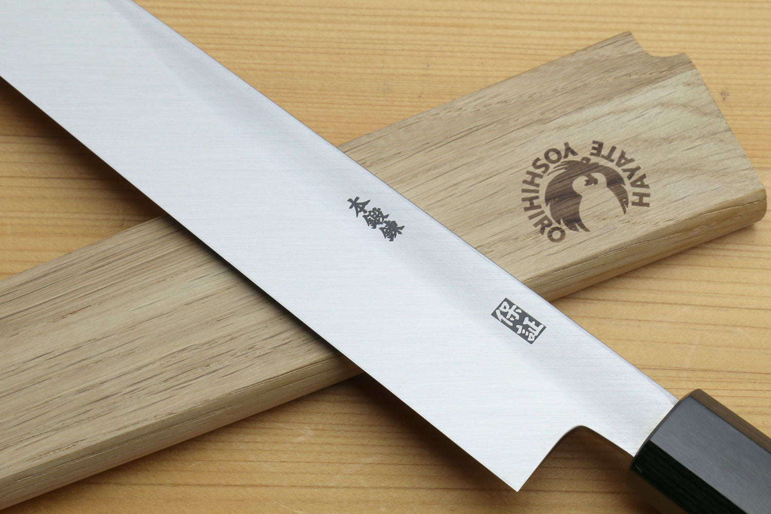Sashimi knife blade detail with etched markings and rosewood handle