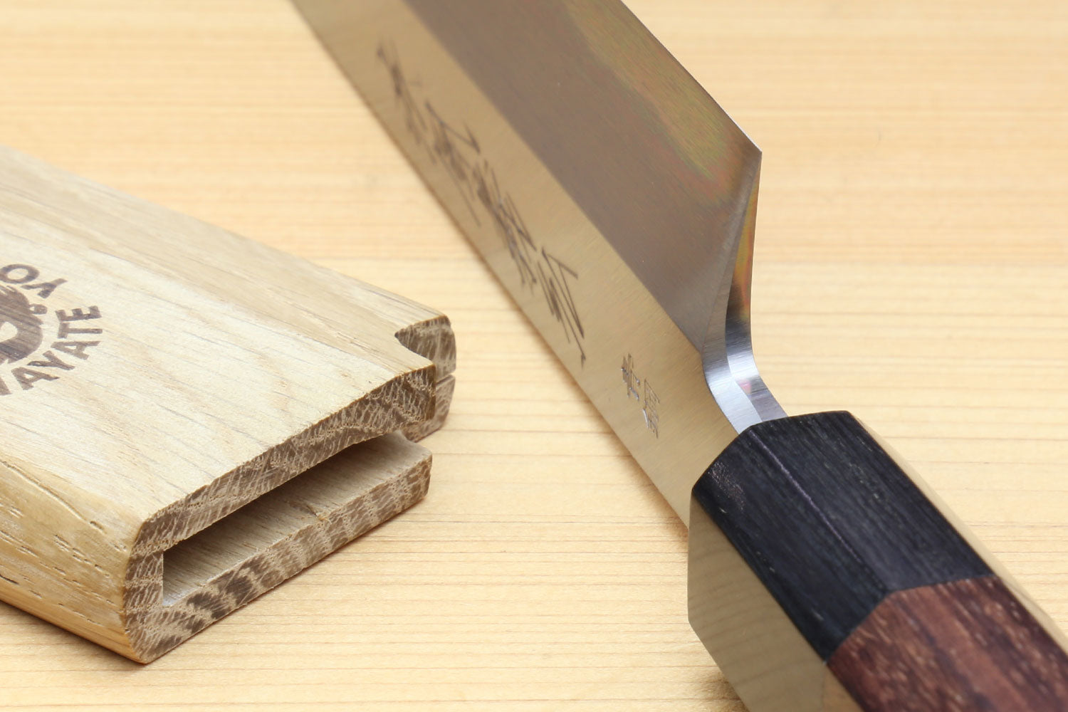 Sashimi knife with dark rosewood handle and polished silver blade, side view