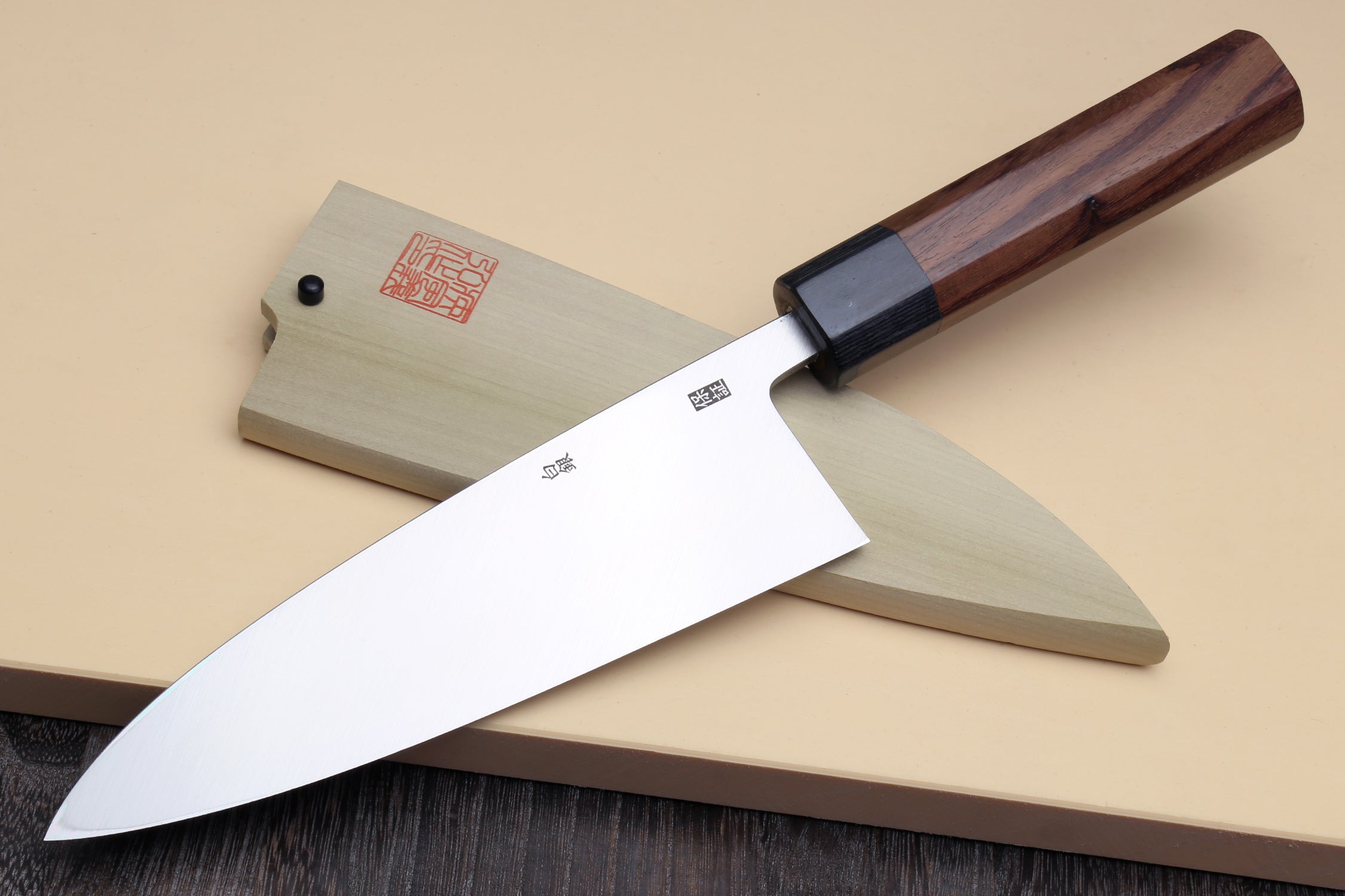 Deba fish fillet knife side view, white blade with dark bolster and rosewood handle