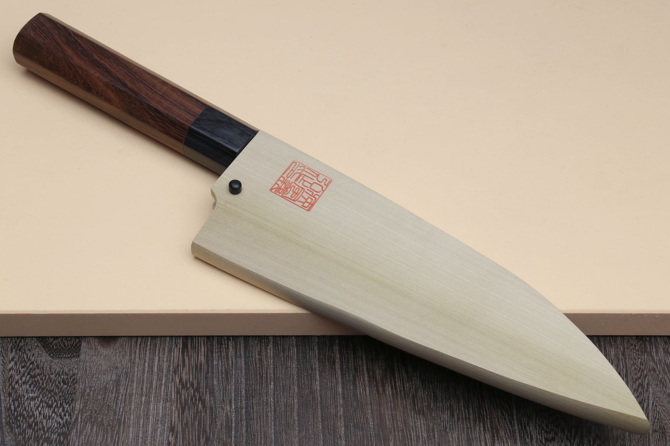 Deba fish fillet knife on stand, pointed white blade and shitan rosewood handle with bolster