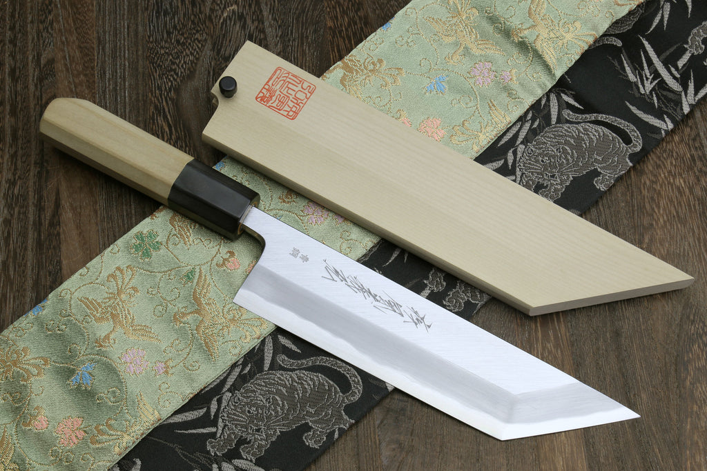 High carbon steel eel filet knife with light wood handle and pale wooden sheath