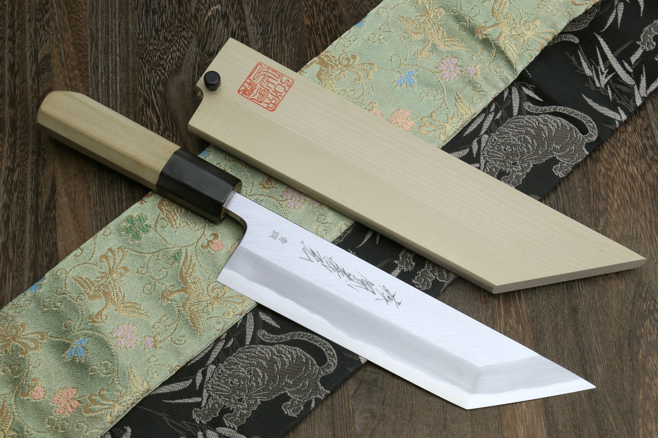 High carbon steel eel filet knife with light wood handle and pale wooden sheath