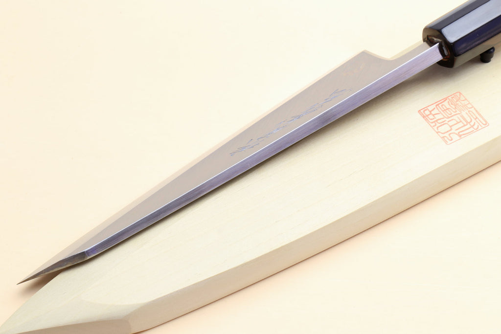 Japanese boning knife side view, pale handle, black collar, polished steel blade edge