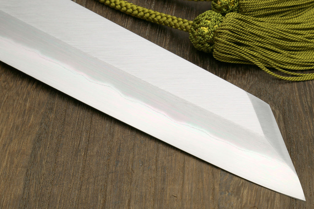 Japanese chef knife white steel blade close-up with straight edge, magnolia handle.