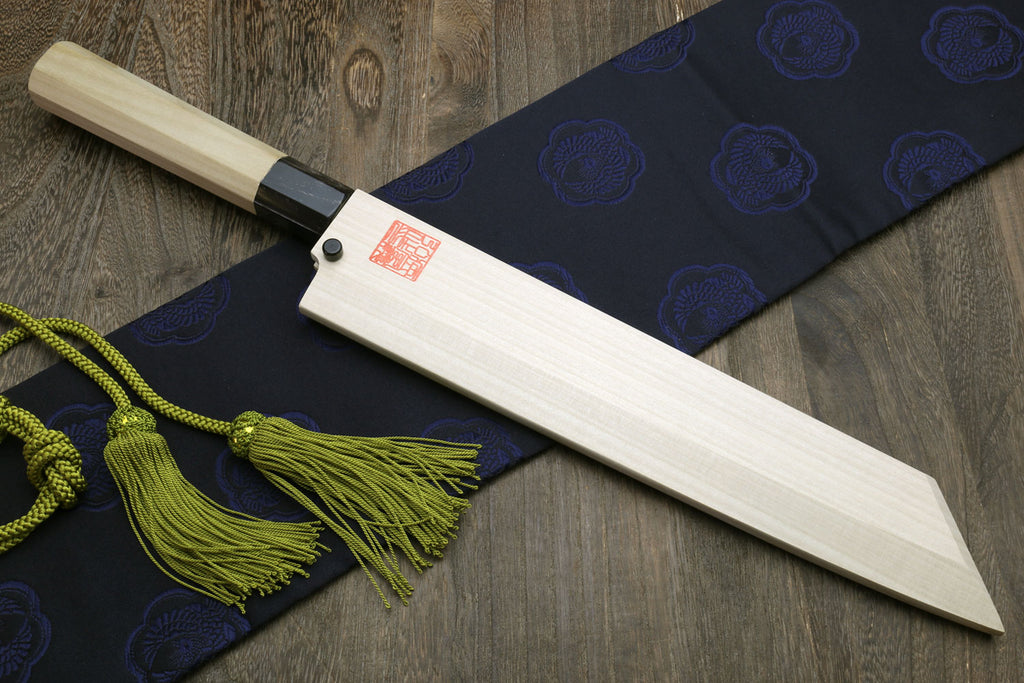 Japanese chef knife with wooden sheath and magnolia handle, green tassel cord.