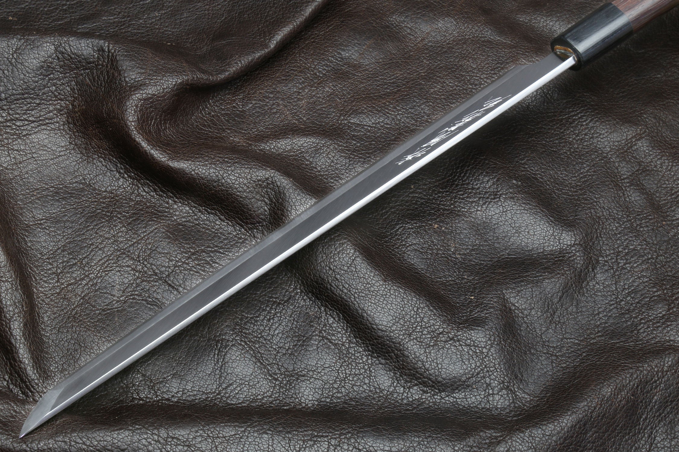 Japanese sushi knife with light steel blade and rosewood handle, tip view