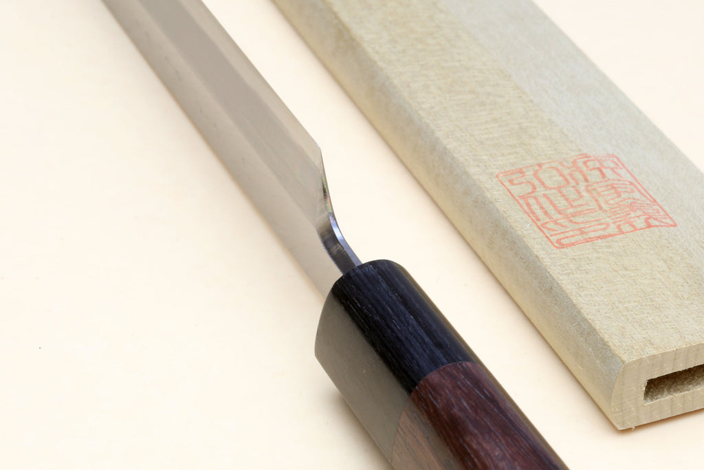 Japanese sushi knife blade edge with rosewood handle and pale wooden saya