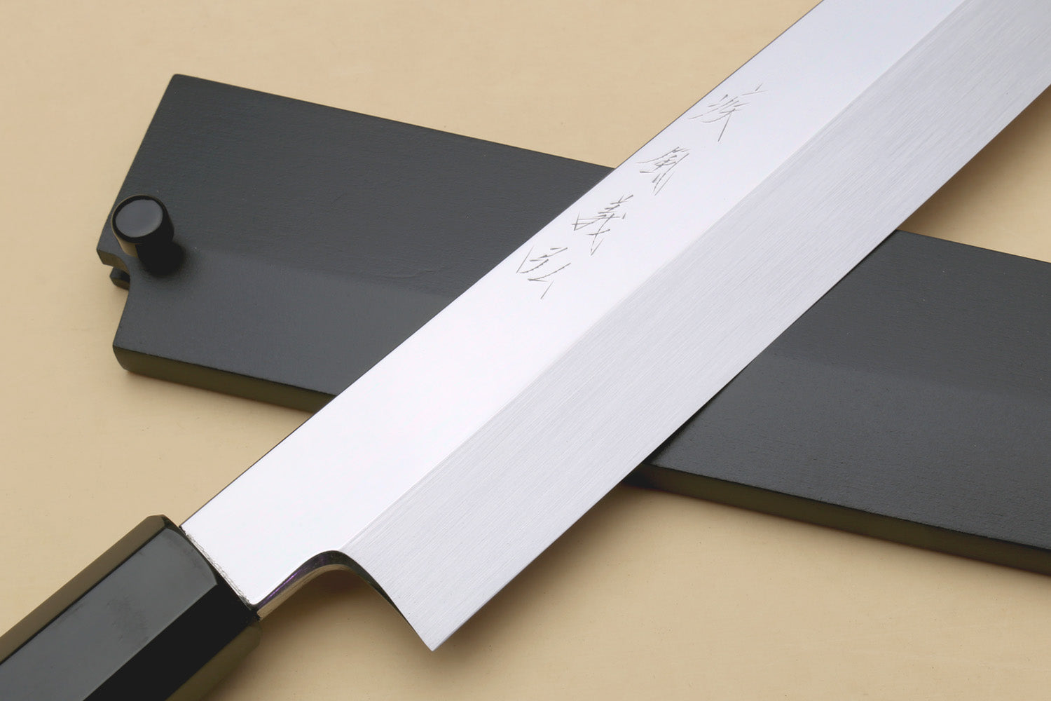 Yanagi sushi knife with mirror-finished blade and dark handle