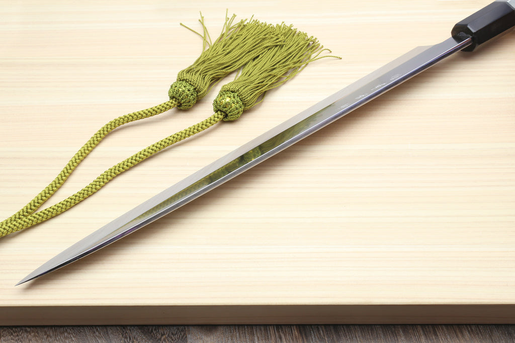 Yanagi sushi knife with silver mirror blade and dark handle, with green cord tassel