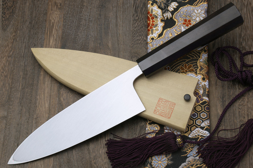 Mirror-finished deba sushi fillet knife with dark handle and light wooden saya
